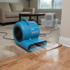 Dri-Eaz Sahara carpet dryer air mover drying a living room floor after a domestic flood