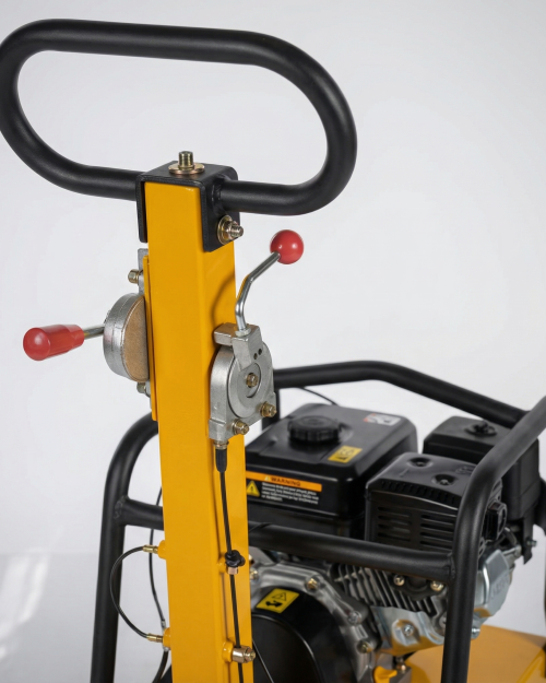 Construction worker using an 18 inch reversible petrol plate compactor on a gravel driveway base